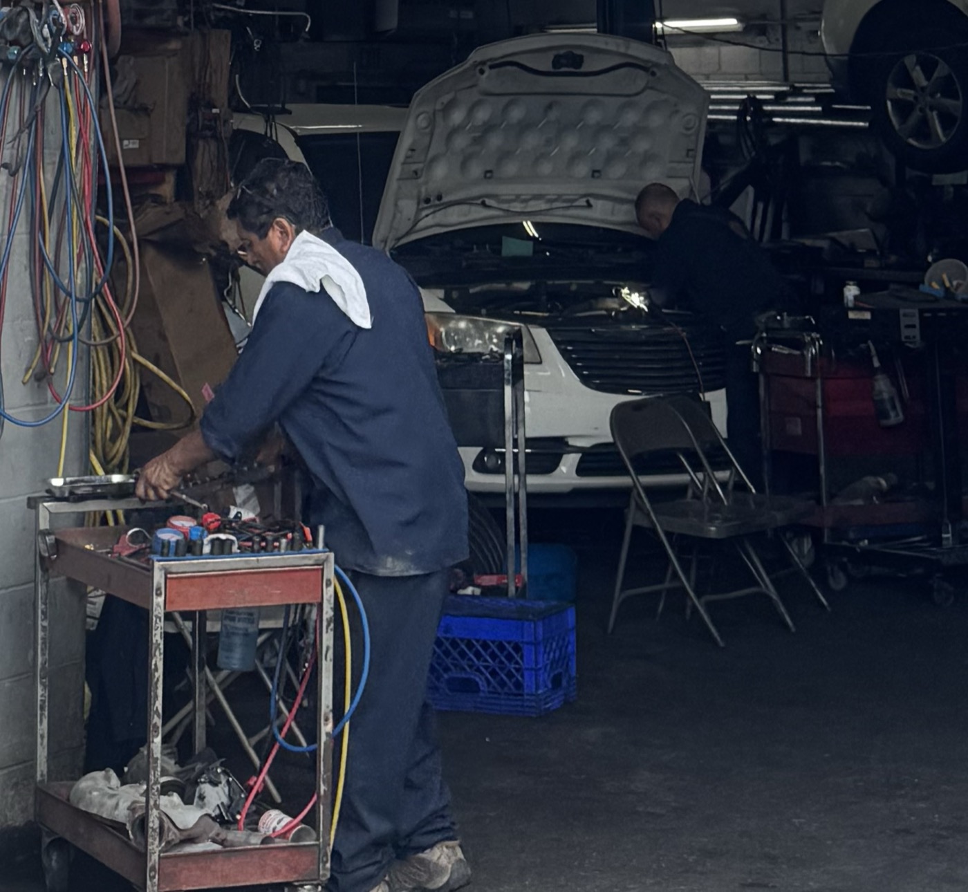 Two F&T mechanics working — A/C service and engine repair
